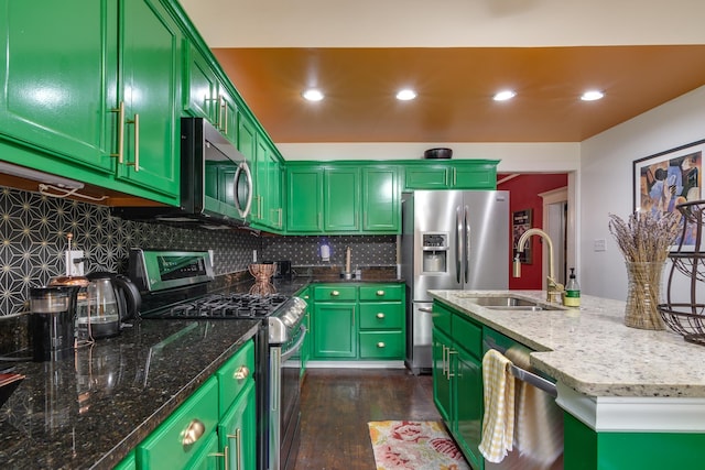 kitchen with a sink, tasteful backsplash, stainless steel appliances, and dark wood-type flooring