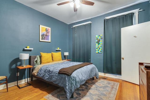 bedroom with wood-type flooring and a ceiling fan