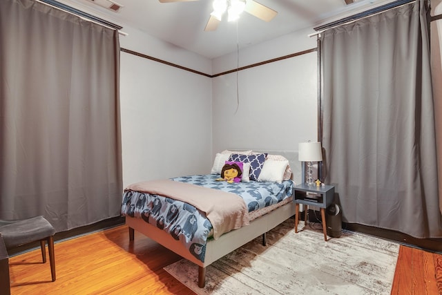 bedroom with ceiling fan and wood finished floors