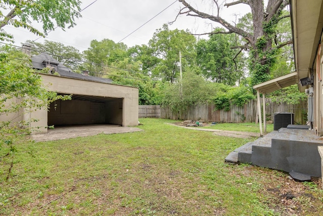 view of yard with an outdoor structure, central AC unit, and a fenced backyard