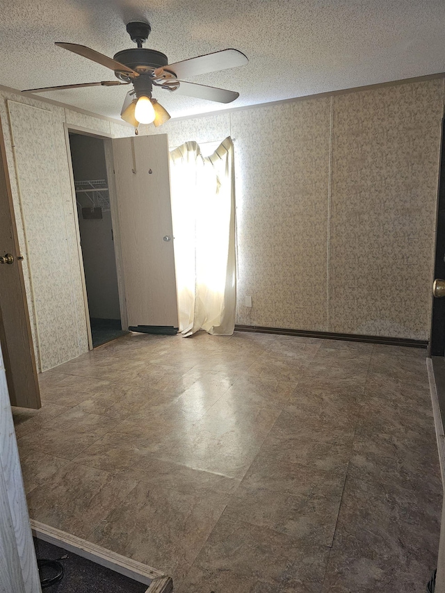 3845 Forked Deer Rd, Gates, TN 38037 - empty room featuring ceiling fan, wallpapered walls, and a textured ceiling