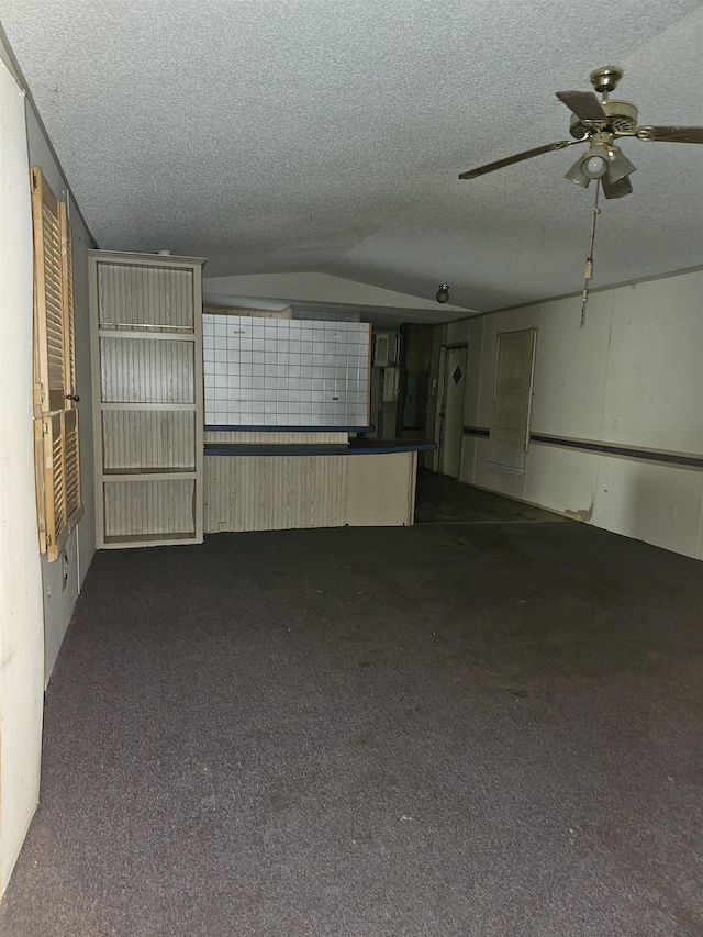 3845 Forked Deer Rd, Gates, TN 38037 - unfurnished living room featuring carpet floors, a ceiling fan, a textured ceiling, and lofted ceiling