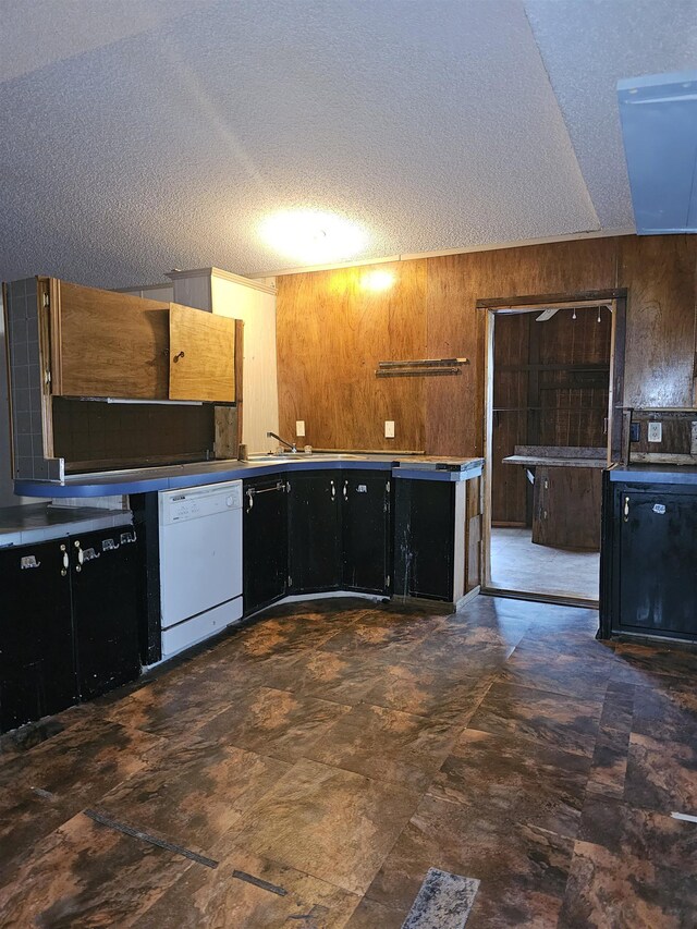 3845 Forked Deer Rd, Gates, TN 38037 - kitchen with wooden walls, dark cabinetry, a textured ceiling, and dishwasher