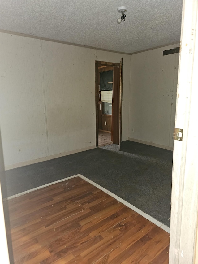 3845 Forked Deer Rd, Gates, TN 38037 - spare room with a textured ceiling and wood finished floors