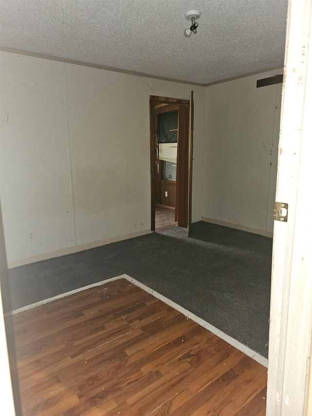 3845 Forked Deer Rd, Gates, TN 38037 - spare room with a textured ceiling and wood finished floors
