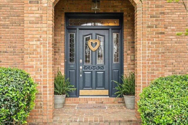 property entrance featuring brick siding