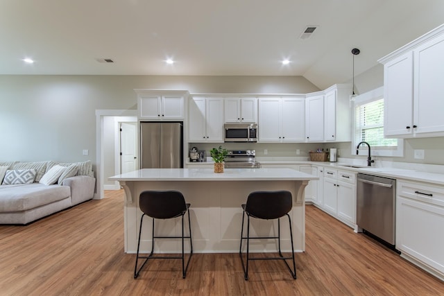 50 Melrose Cv, Savannah, TN 38372 - kitchen with white cabinetry, appliances with stainless steel finishes, a breakfast bar area, and a sink