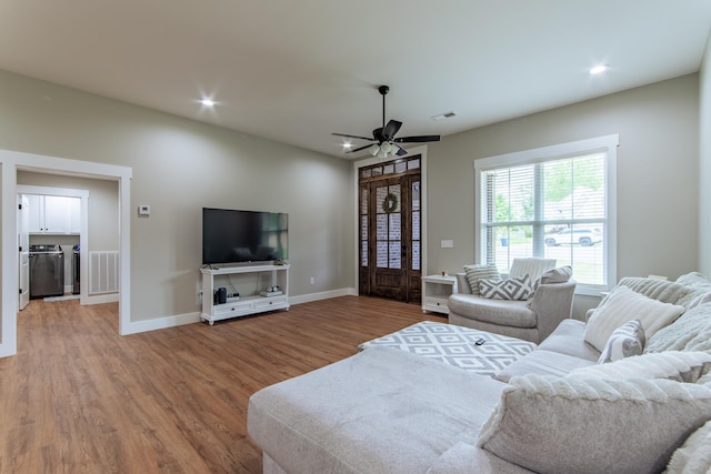 50 Melrose Cv, Savannah, TN 38372 - living room featuring separate washer and dryer, visible vents, wood finished floors, and ceiling fan