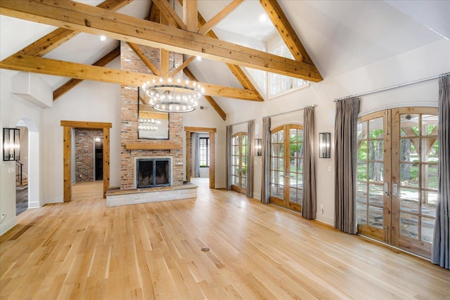 294 Dubray Manor Dr, Collierville, TN 38017 - unfurnished living room with an inviting chandelier, light wood-style floors, high vaulted ceiling, french doors, and beamed ceiling