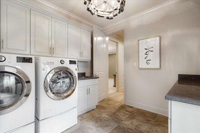 294 Dubray Manor Dr, Collierville, TN 38017 - clothes washing area with cabinet space, baseboards, an inviting chandelier, ornamental molding, and washer and clothes dryer