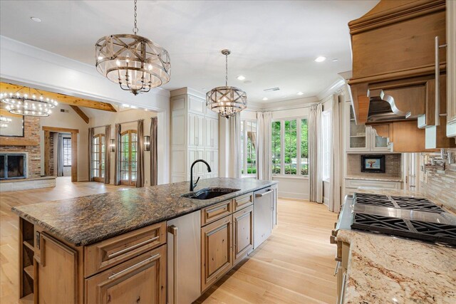 294 Dubray Manor Dr, Collierville, TN 38017 - kitchen with light wood-style floors, a sink, a chandelier, and tasteful backsplash