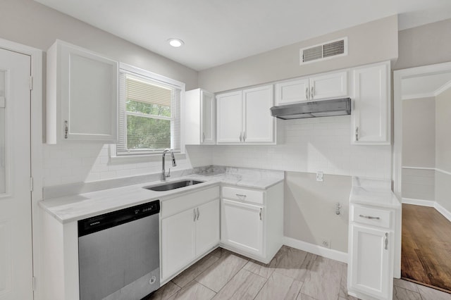 kitchen with stainless steel dishwasher, white cabinets, visible vents, and a sink