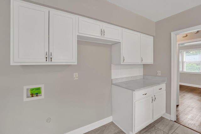 4277 Rhodes Ave, Memphis, TN 38111 - kitchen featuring light countertops, baseboards, and white cabinets