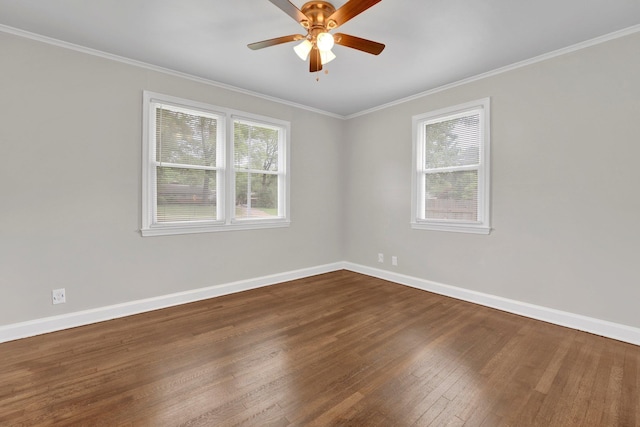 empty room featuring a healthy amount of sunlight, baseboards, and wood finished floors