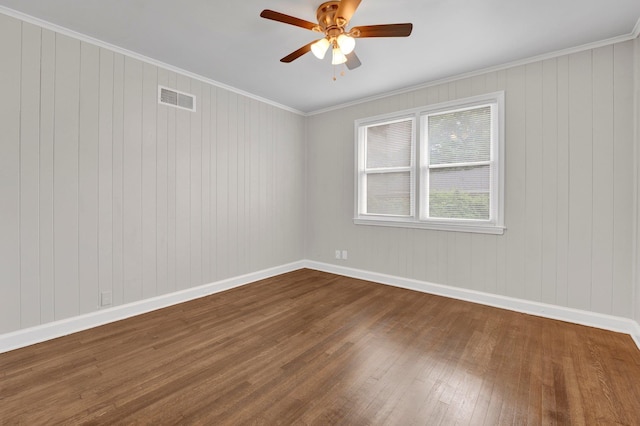 unfurnished room with visible vents, a ceiling fan, dark wood-style flooring, and baseboards