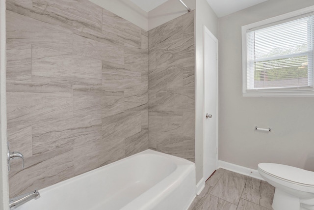 full bath featuring baseboards, marble finish floor, shower / bathtub combination, and toilet