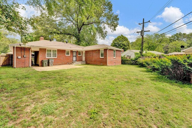 4277 Rhodes Ave, Memphis, TN 38111 - rear view of property featuring fence, a chimney, a lawn, and brick siding
