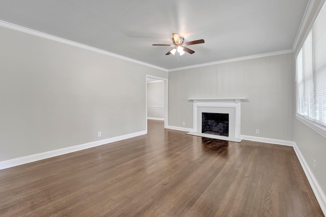 unfurnished living room featuring a ceiling fan, dark wood finished floors, a fireplace, and ornamental molding