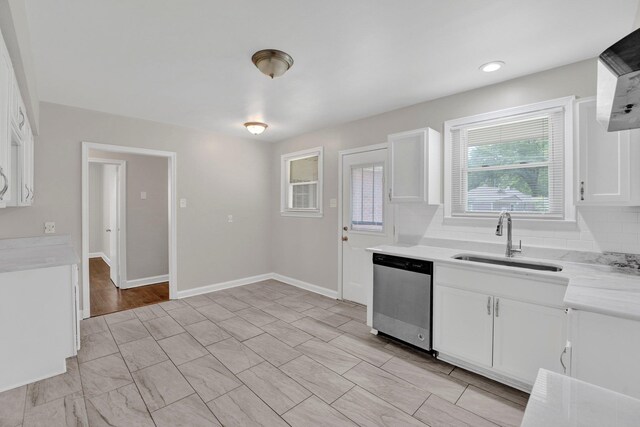 4277 Rhodes Ave, Memphis, TN 38111 - kitchen featuring light countertops, white cabinetry, a sink, dishwasher, and exhaust hood