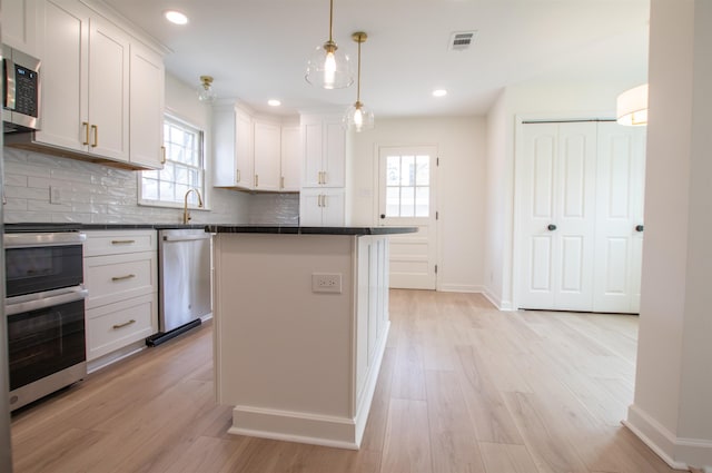 5483 Brantford Rd, Memphis, TN 38120 - kitchen with dark countertops, plenty of natural light, stainless steel appliances, and visible vents