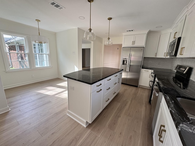5483 Brantford Rd, Memphis, TN 38120 - kitchen featuring baseboards, tasteful backsplash, stainless steel appliances, and light wood finished floors