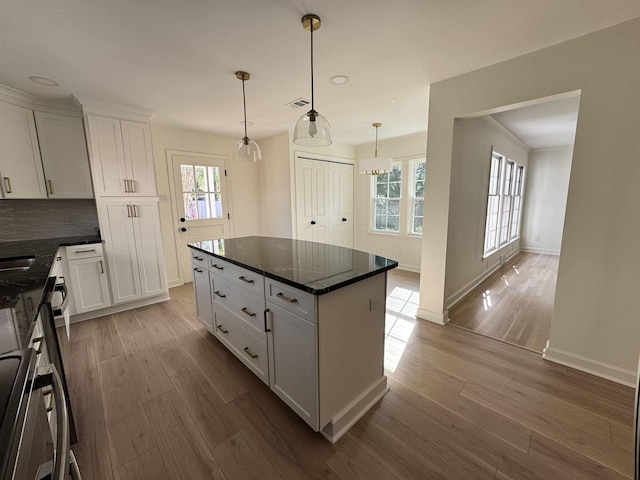 5483 Brantford Rd, Memphis, TN 38120 - kitchen with baseboards, white cabinetry, wood finished floors, and a wealth of natural light