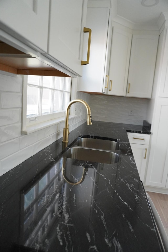 5483 Brantford Rd, Memphis, TN 38120 - kitchen with white cabinetry, decorative backsplash, a sink, and dark stone countertops