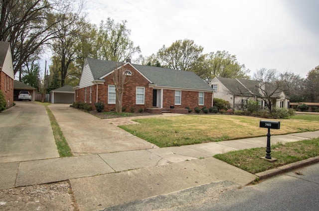 5483 Brantford Rd, Memphis, TN 38120 - view of front of property with a front yard, a garage, brick siding, an outdoor structure, and a shingled roof