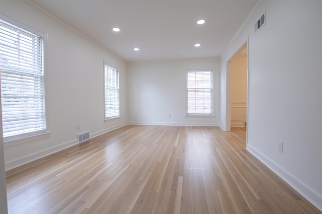 5483 Brantford Rd, Memphis, TN 38120 - spare room featuring visible vents, light wood-style flooring, and a healthy amount of sunlight
