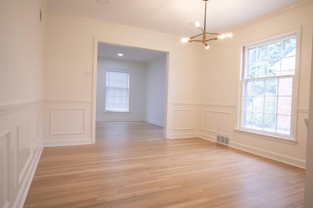 5483 Brantford Rd, Memphis, TN 38120 - unfurnished room featuring an inviting chandelier, ornamental molding, a decorative wall, and visible vents