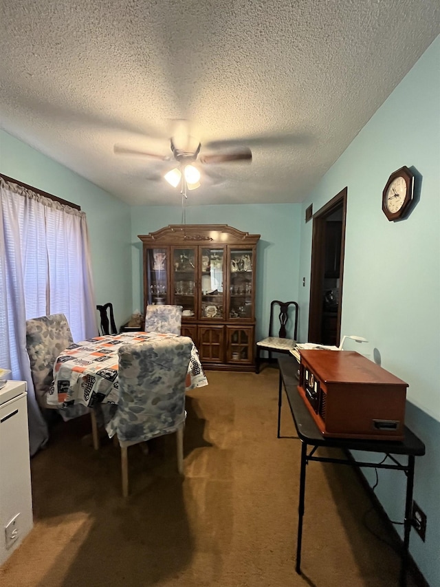 bedroom with a ceiling fan, a textured ceiling, and light carpet