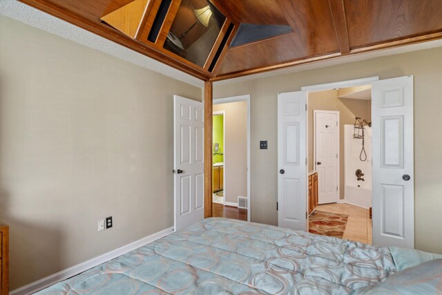 bedroom with baseboards, visible vents, and tile patterned floors