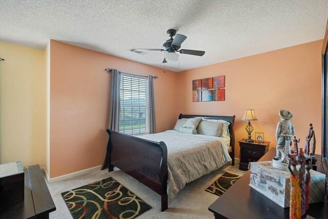 carpeted bedroom with baseboards, a ceiling fan, and a textured ceiling