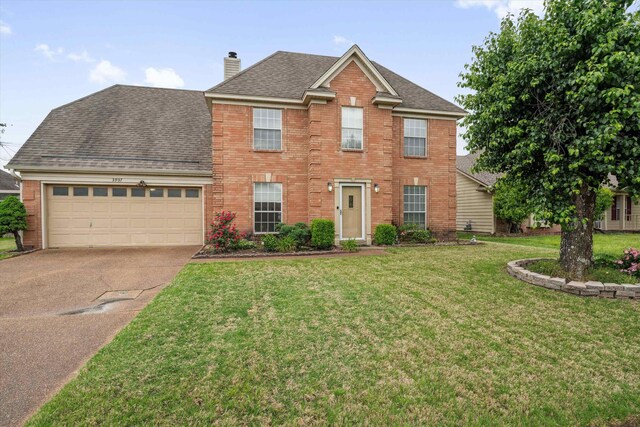 colonial home with brick siding, a garage, a shingled roof, and concrete driveway