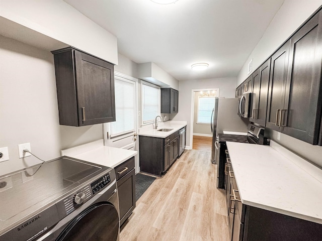 1439 Woodston Rd, Memphis, TN 38117 - laundry area with laundry area, a sink, light wood-style floors, washer / clothes dryer, and visible vents
