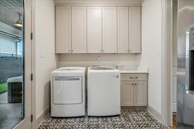 330 Mary Taylor Way, Piperton, TN 38017 - laundry area with washing machine and clothes dryer, cabinet space, baseboards, and light tile patterned floors