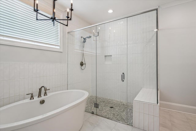 330 Mary Taylor Way, Piperton, TN 38017 - bathroom featuring a stall shower, a freestanding tub, a chandelier, tile patterned flooring, and tile walls