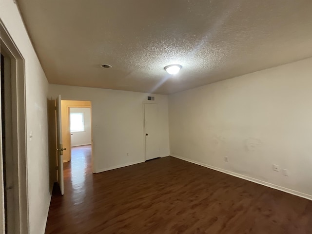 4805 Northfield Cir, Memphis, TN 38128 - unfurnished room with baseboards, a textured ceiling, and dark wood-type flooring