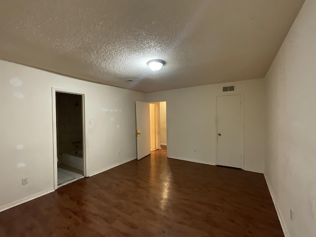 4805 Northfield Cir, Memphis, TN 38128 - spare room featuring visible vents, baseboards, a textured ceiling, and wood finished floors