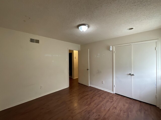 4805 Northfield Cir, Memphis, TN 38128 - unfurnished bedroom with a textured ceiling, visible vents, wood finished floors, baseboards, and a closet