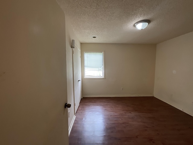 4805 Northfield Cir, Memphis, TN 38128 - empty room with baseboards, a textured ceiling, and dark wood-style floors