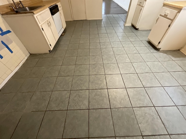 4805 Northfield Cir, Memphis, TN 38128 - kitchen with white dishwasher, a sink, light countertops, white cabinetry, and light tile patterned floors