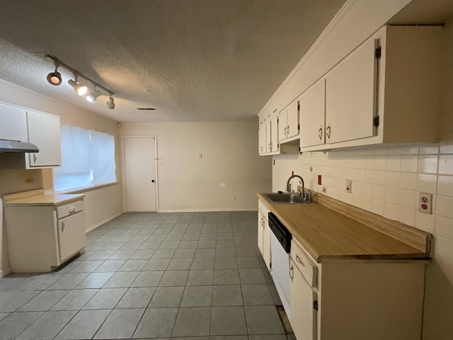 4805 Northfield Cir, Memphis, TN 38128 - kitchen featuring a sink, a textured ceiling, white cabinetry, light tile patterned floors, and tasteful backsplash