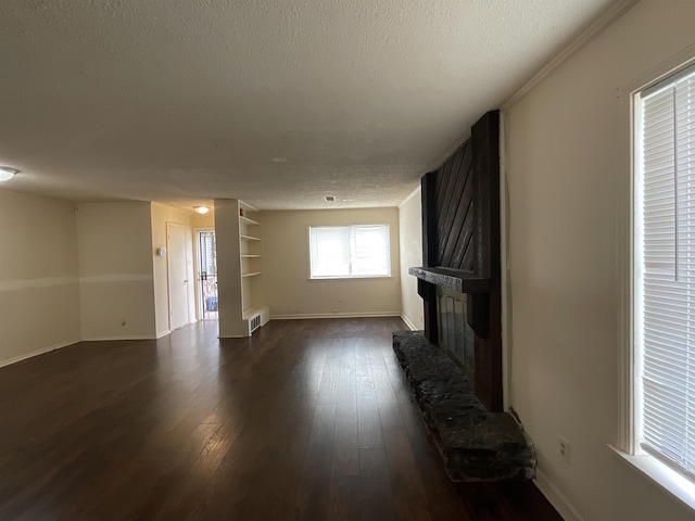 4805 Northfield Cir, Memphis, TN 38128 - unfurnished living room featuring a textured ceiling, dark wood-style floors, baseboards, and a fireplace