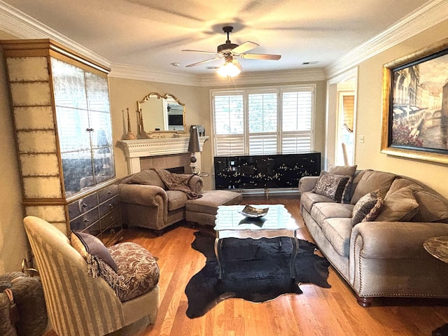 10202 Wynmanor Dr, Collierville, TN 38017 - living room with ceiling fan, wood finished floors, crown molding, and a tiled fireplace