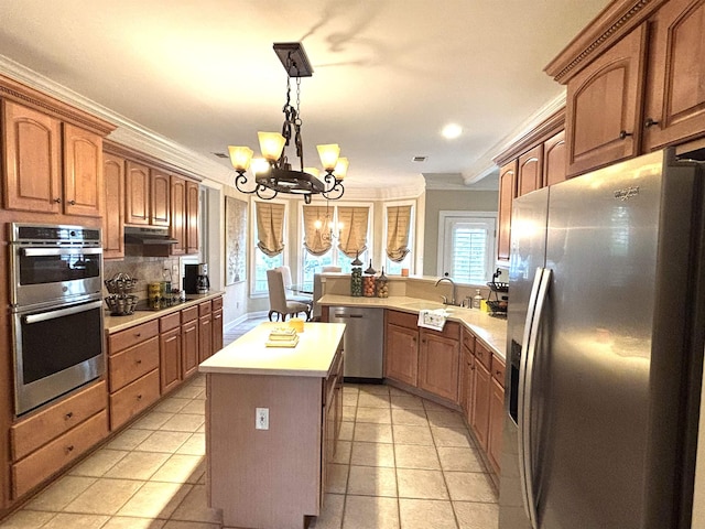10202 Wynmanor Dr, Collierville, TN 38017 - kitchen with appliances with stainless steel finishes, a chandelier, a sink, crown molding, and light countertops