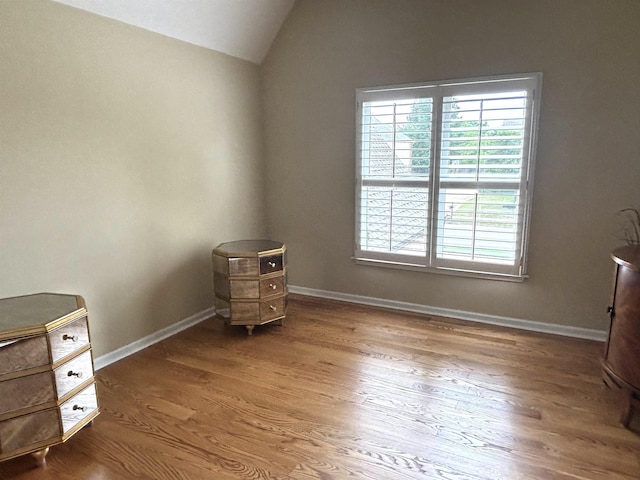 10202 Wynmanor Dr, Collierville, TN 38017 - unfurnished bedroom featuring vaulted ceiling, multiple windows, wood finished floors, and baseboards