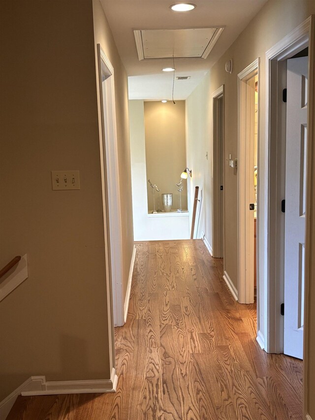 10202 Wynmanor Dr, Collierville, TN 38017 - hall with attic access, wood finished floors, and baseboards