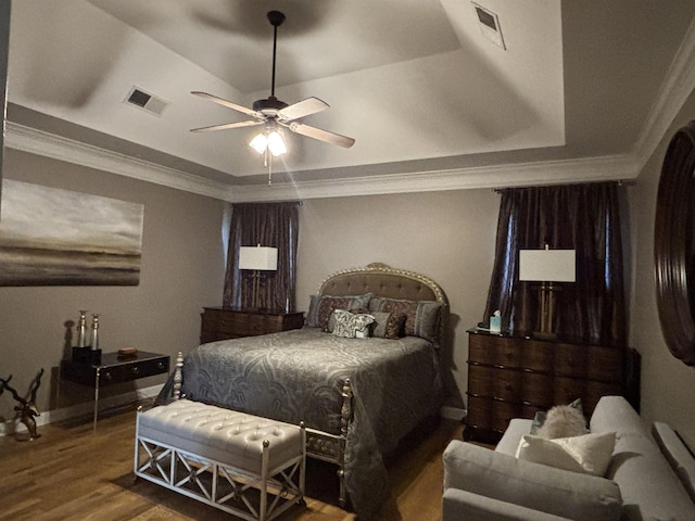 10202 Wynmanor Dr, Collierville, TN 38017 - bedroom featuring a tray ceiling, wood finished floors, crown molding, a ceiling fan, and baseboards