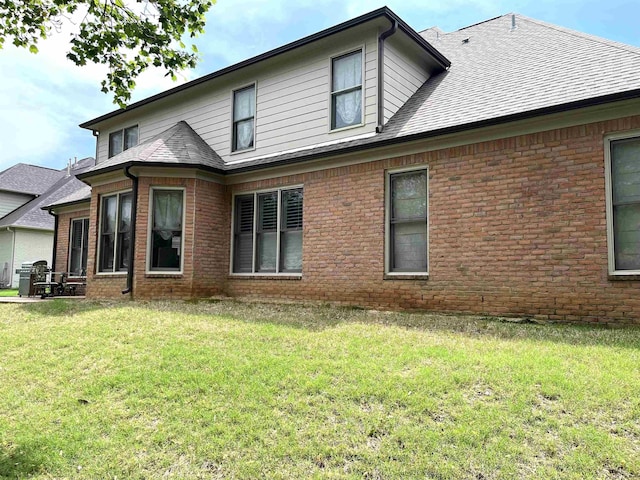 10202 Wynmanor Dr, Collierville, TN 38017 - rear view of house featuring brick siding, a lawn, and a shingled roof